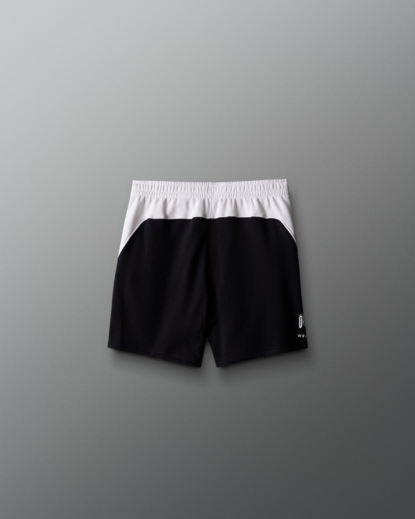 Black shorts with white waistband on a gray background