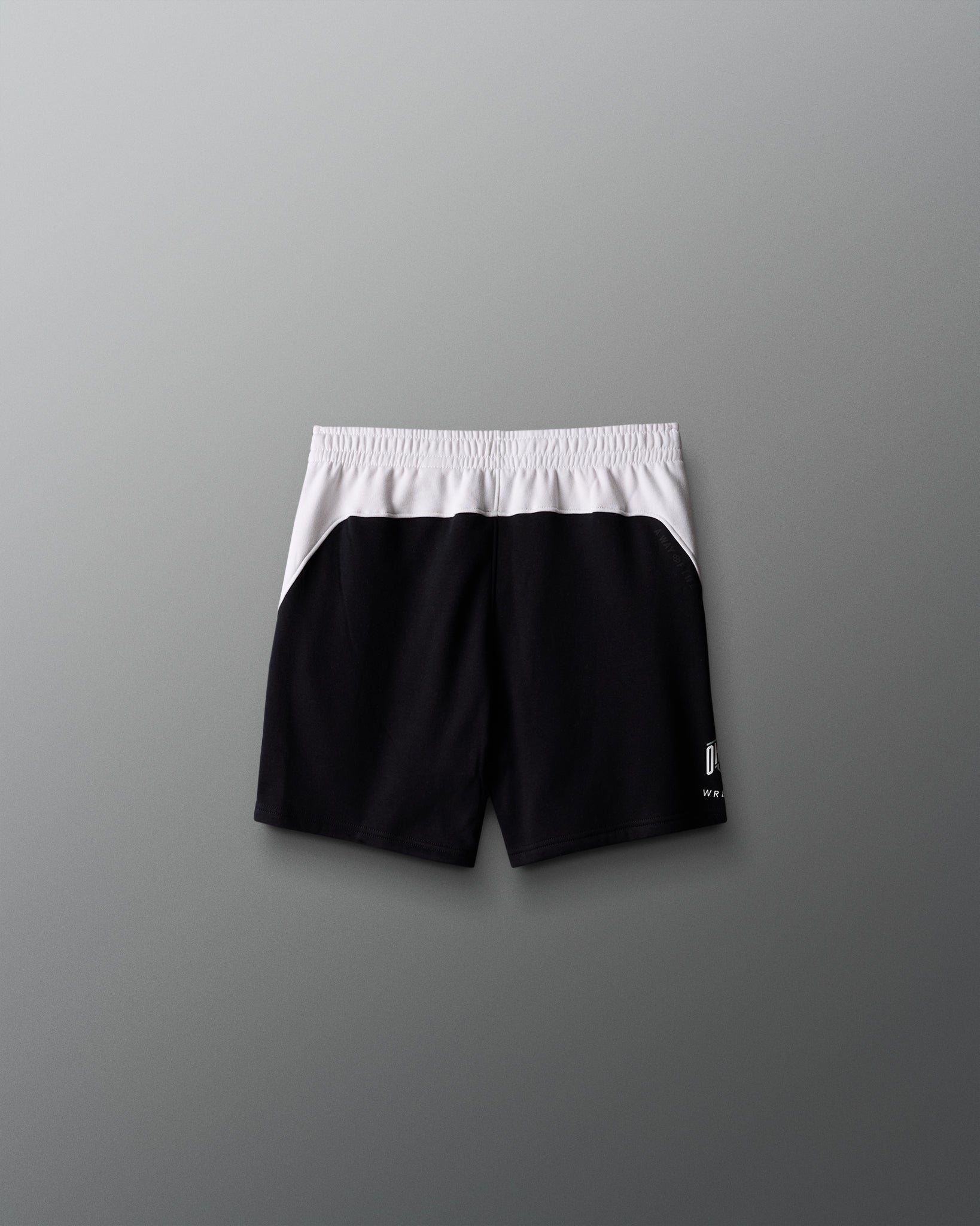 Black shorts with white waistband on a gray background