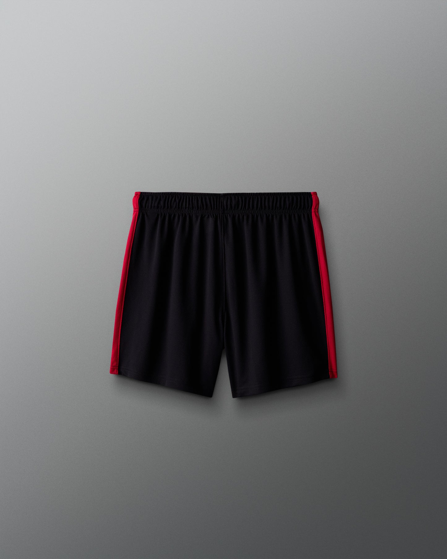 Black shorts with red accents on a gray background