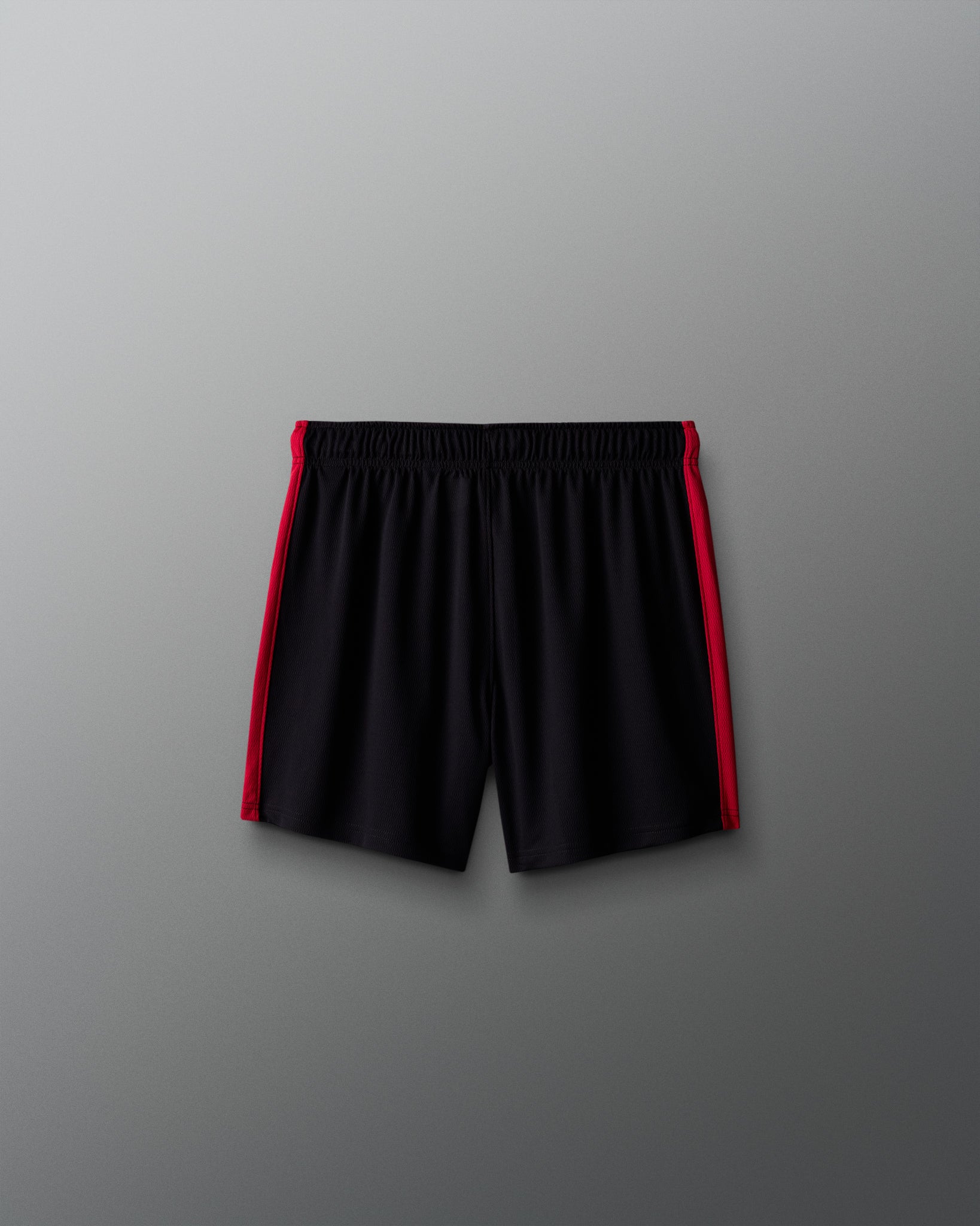 Black shorts with red accents on a gray background