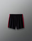 Black shorts with red accents on a gray background