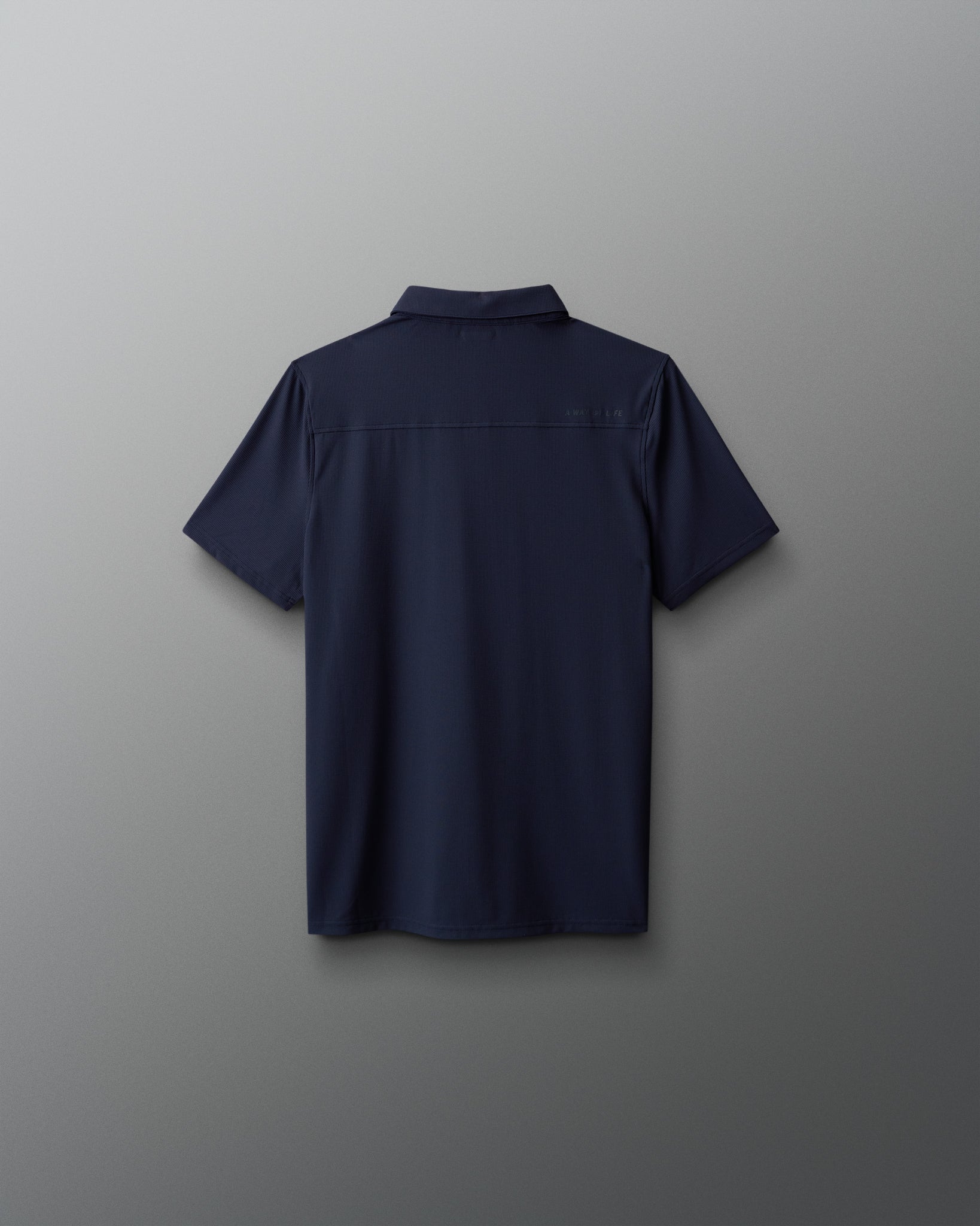 Navy blue polo shirt on a light gray background