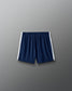 Navy shorts with white trim on a gray background