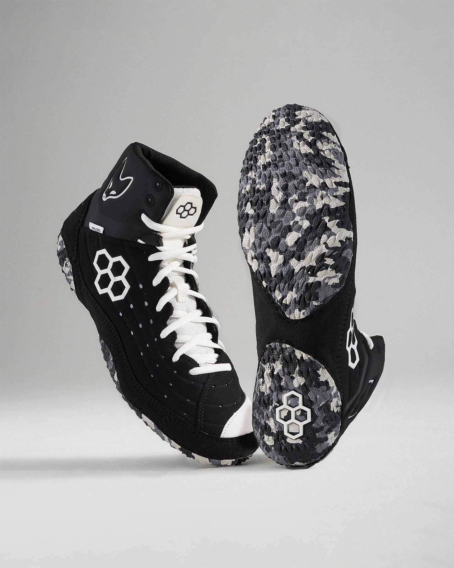 High-top black athletic shoes with white laces and a textured sole designed for performance