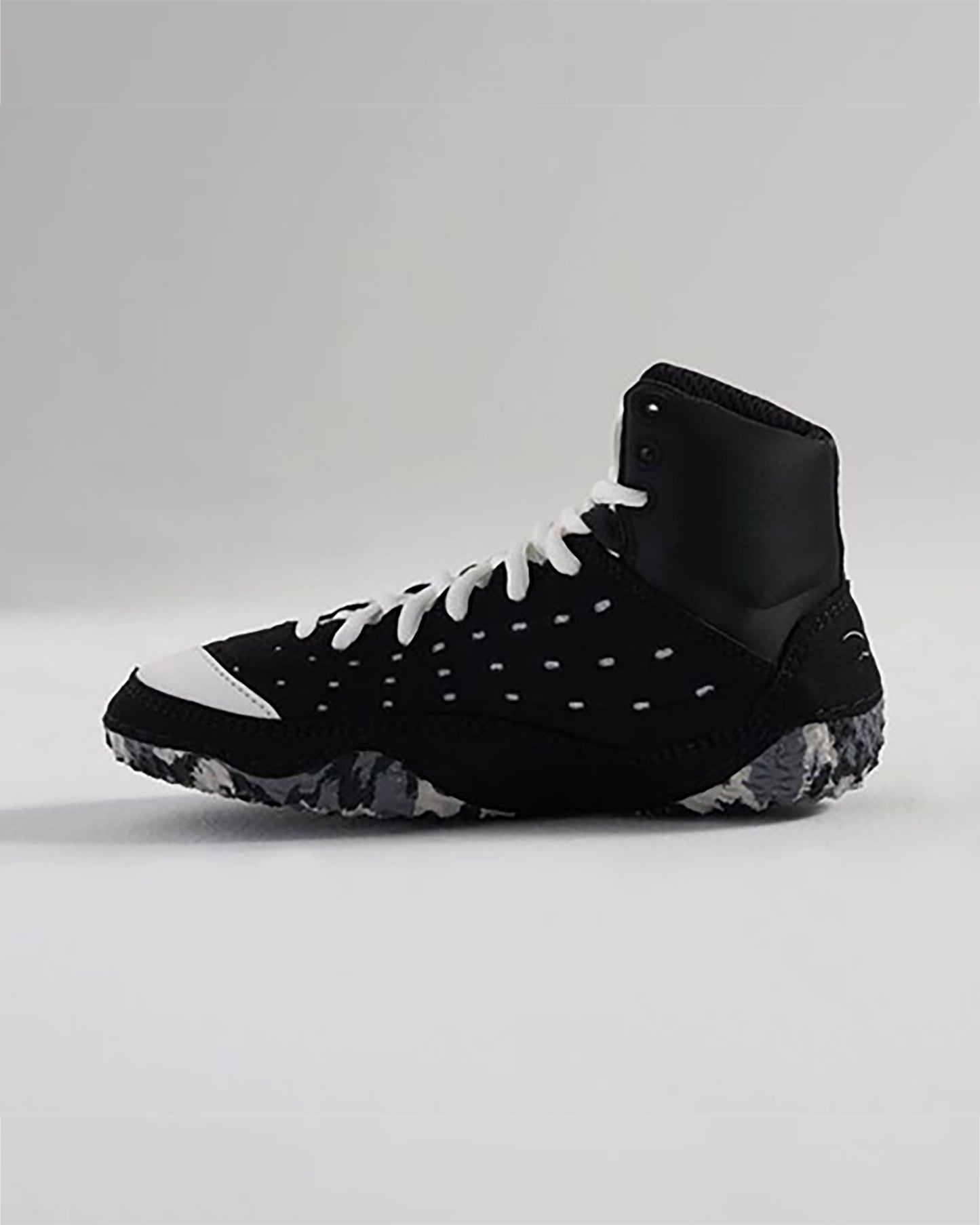 The image showcases a stylish black athletic shoe with distinctive white accents designed for both performance and aesthetics