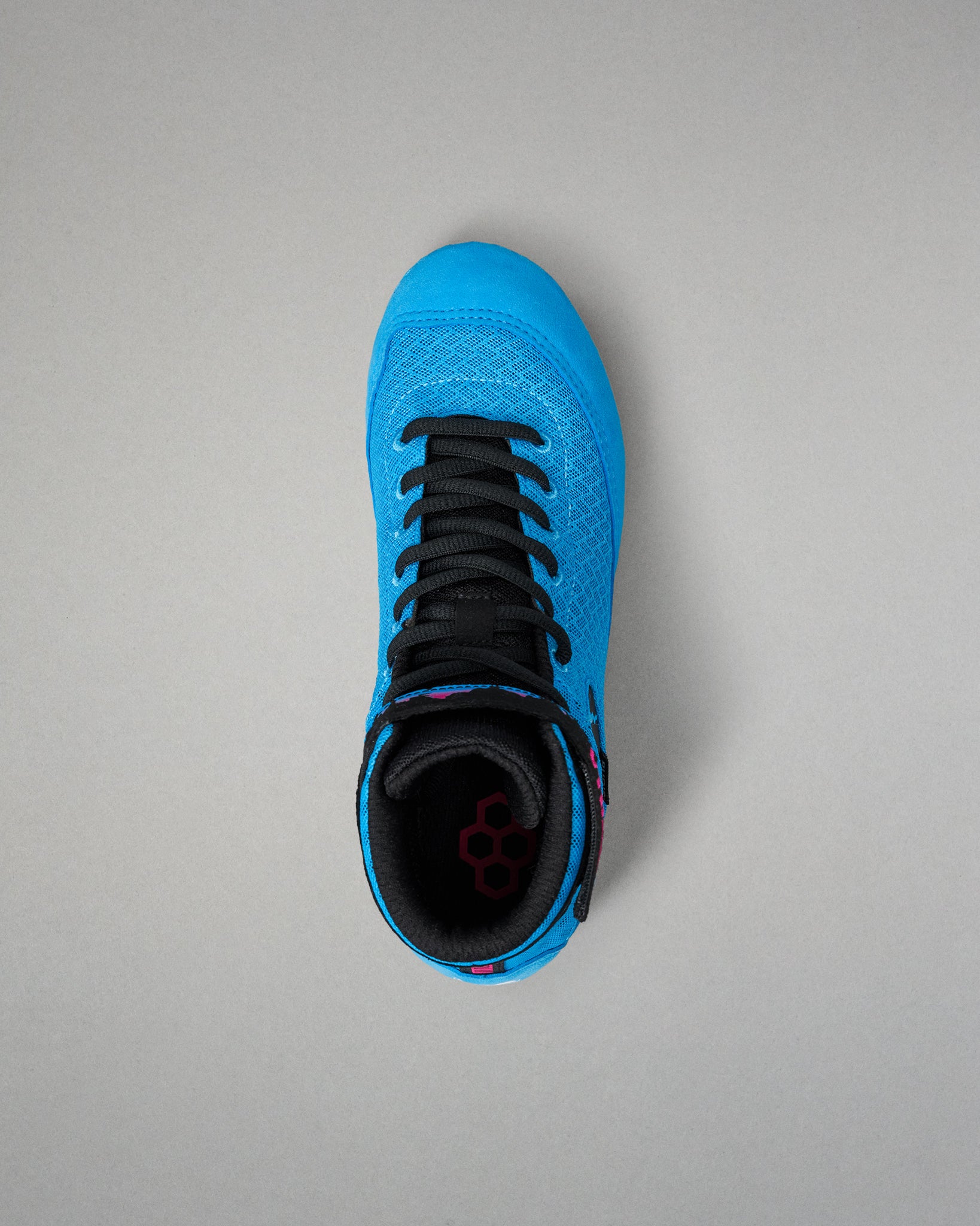 A bright blue wrestling shoe with black laces and a black interior, shown from a top-down view on a neutral gray background.