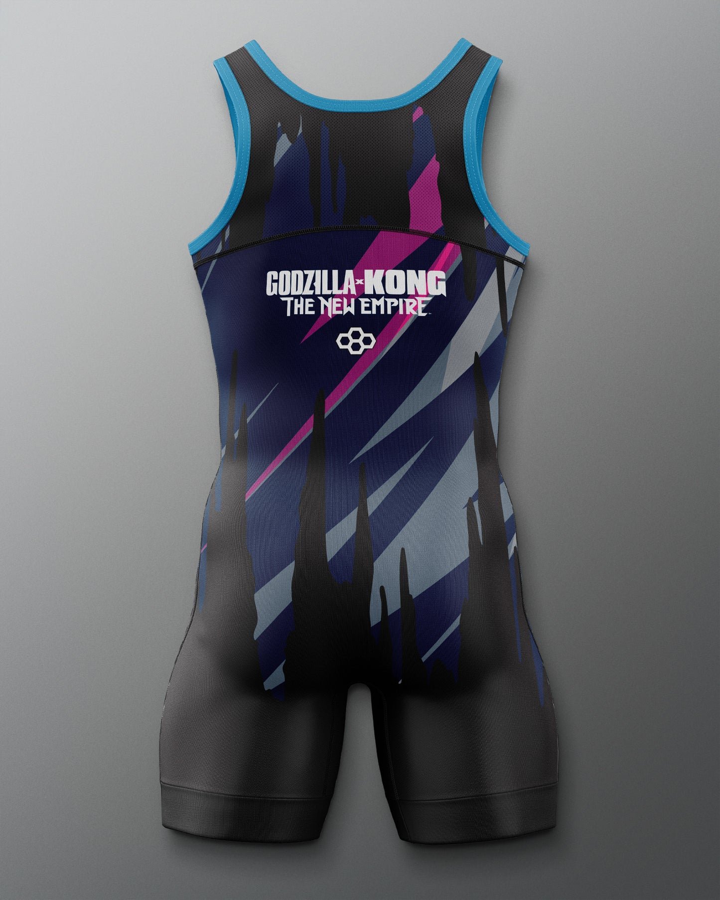 A sleeveless wrestling singlet with a black base and diagonal blue, purple, and pink graphic stripes, featuring the text 'GODZILLA-KONG THE NEW EMPIRE' and a logo on the chest, shown against a gray gradient background.