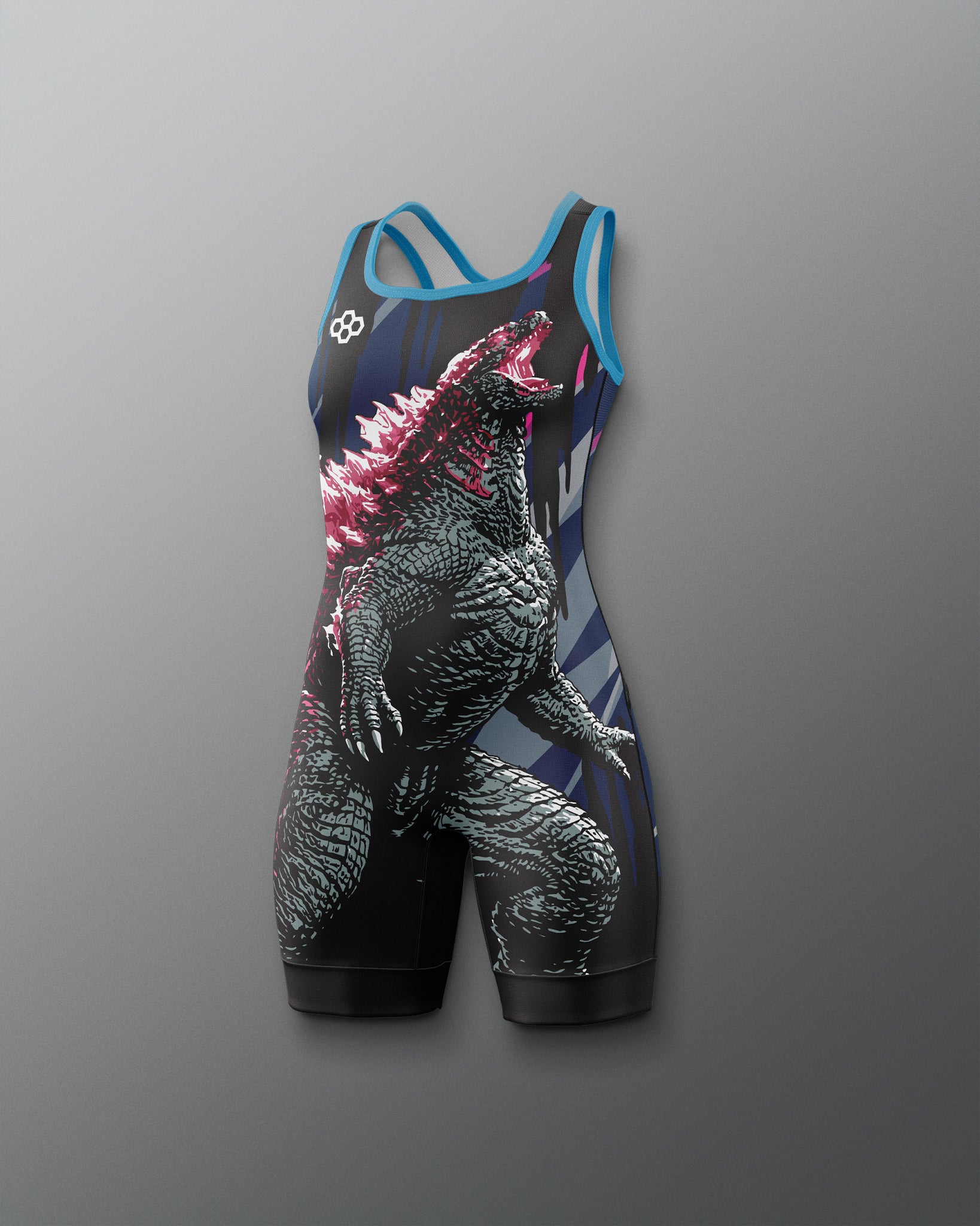 A sleeveless athletic wrestling singlet with a large Godzilla graphic print, featuring a black and gray monster design with pink spikes and blue trim, shown against a gray gradient background.