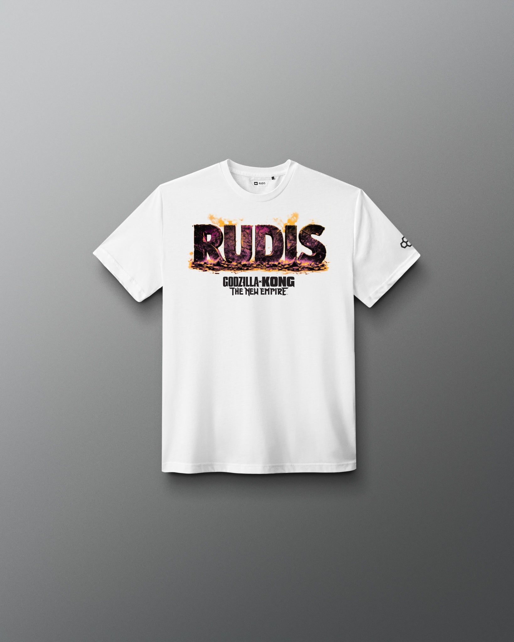 A white short-sleeve crewneck t-shirt with a graphic on the chest reading 'RUDIS' in a fiery textured font and 'GODZILLA-KONG THE new empire underneath, displayed on a clean gray gradient background.