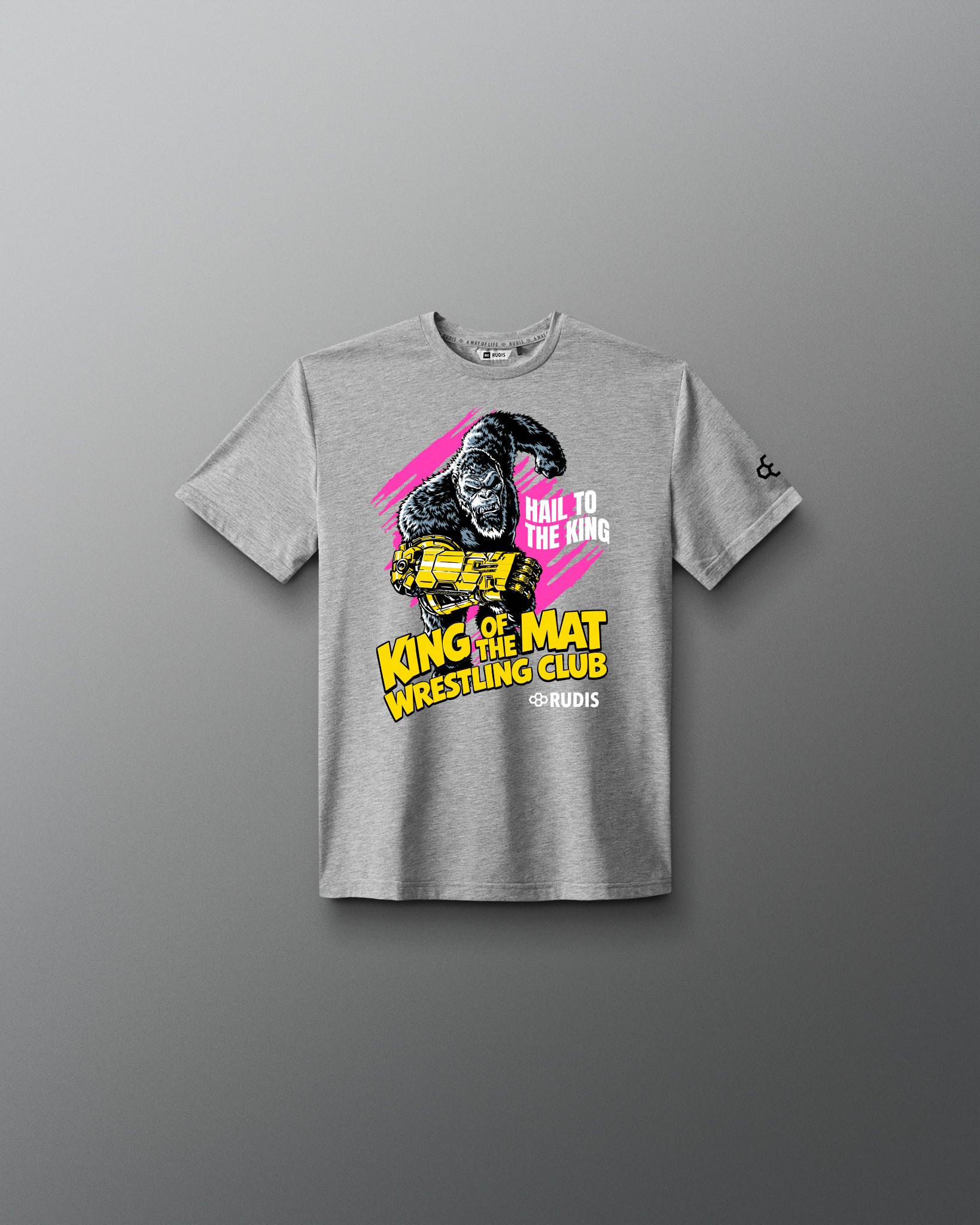 A heather gray short-sleeve t-shirt with a graphic print of a gorilla wearing a yellow crown, set against a pink and yellow background with the text 'HAIL TO THE KING', 'KING OF THE MAT', and 'WRESTLING CLUB'.