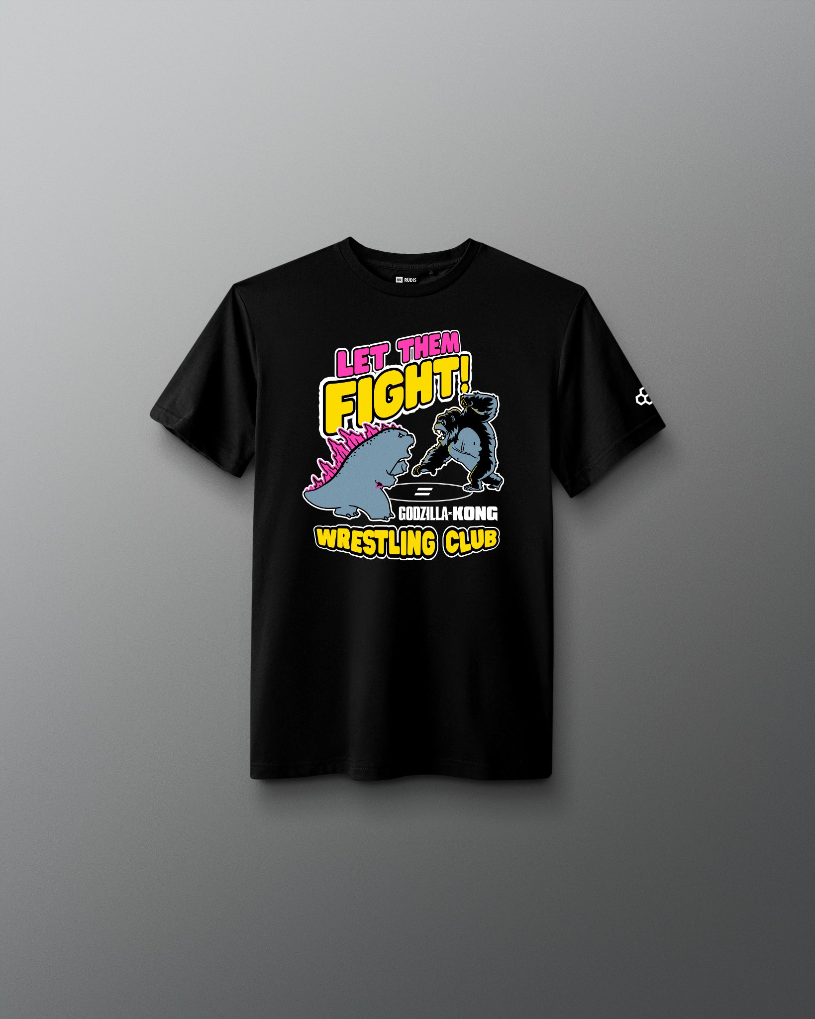 A black short-sleeve t-shirt with a colorful graphic on the front that reads 'LET THEM FIGHT! GORILLA WRESTLING CLUB' with a cartoon gorilla and pink, yellow, and blue details, shown against a dark gray gradient background.