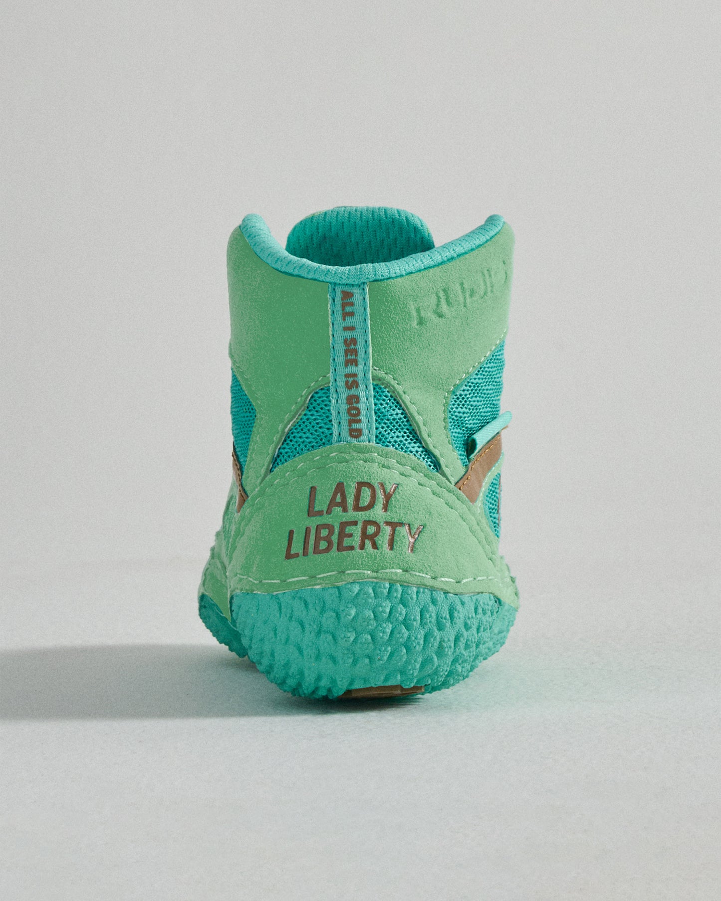 A vibrant turquoise athletic shoe featuring a unique design with the text LADY LIBERTY prominently displayed on the back