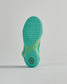 A close-up view of the textured sole of a vibrant turquoise athletic shoe showcasing its unique grip design and color contrast with a light green midsole
