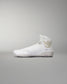 White high-top athletic shoe with smooth design, gold logo detail, and textured sole for grip against a soft gray background.