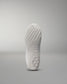 The outsole of a white athletic shoe showcases intricate patterns for traction, highlighted against a light gray background.