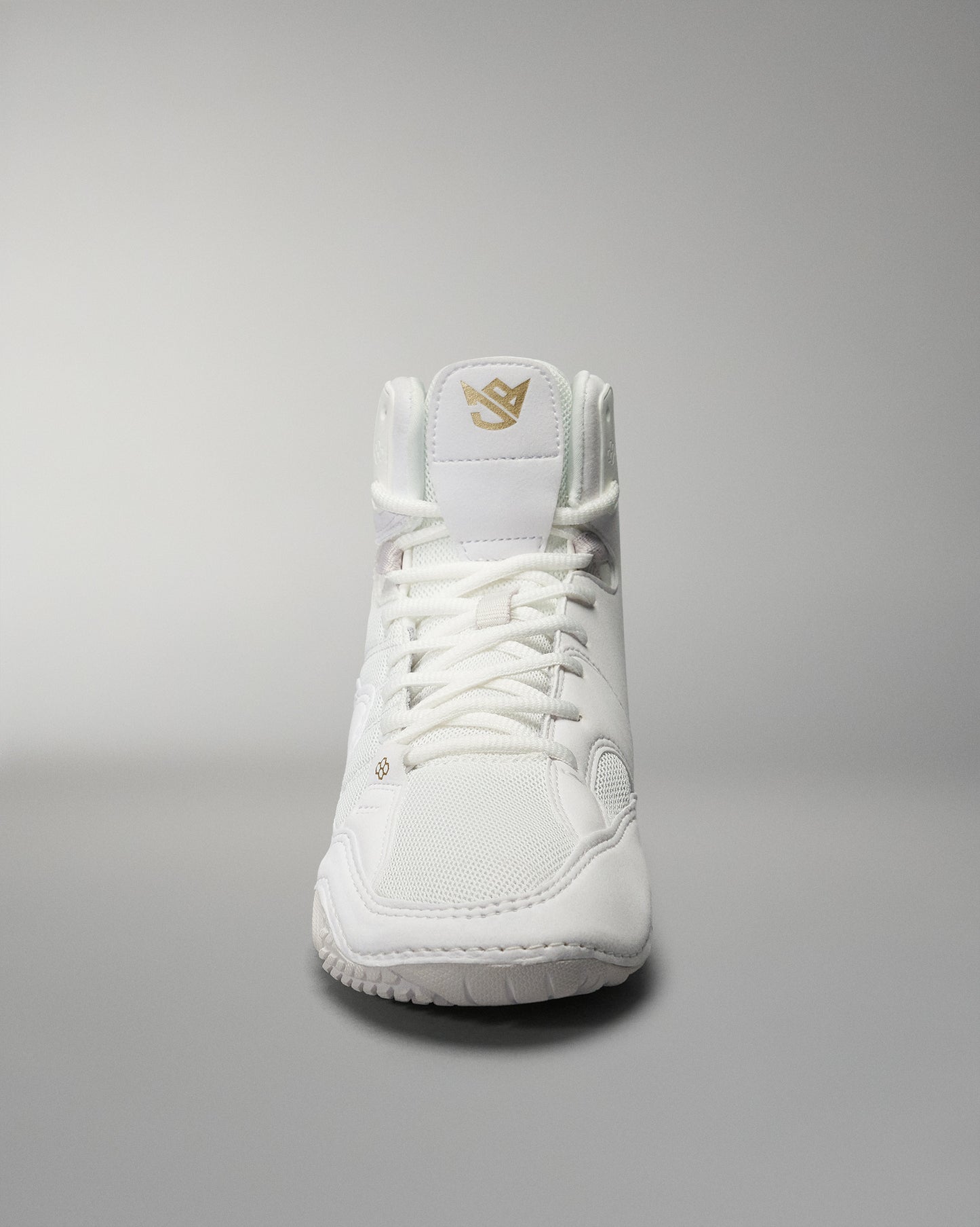 A high-top athletic shoe in white showcases a simple design with a gold logo on the tongue, set against a gradient background.