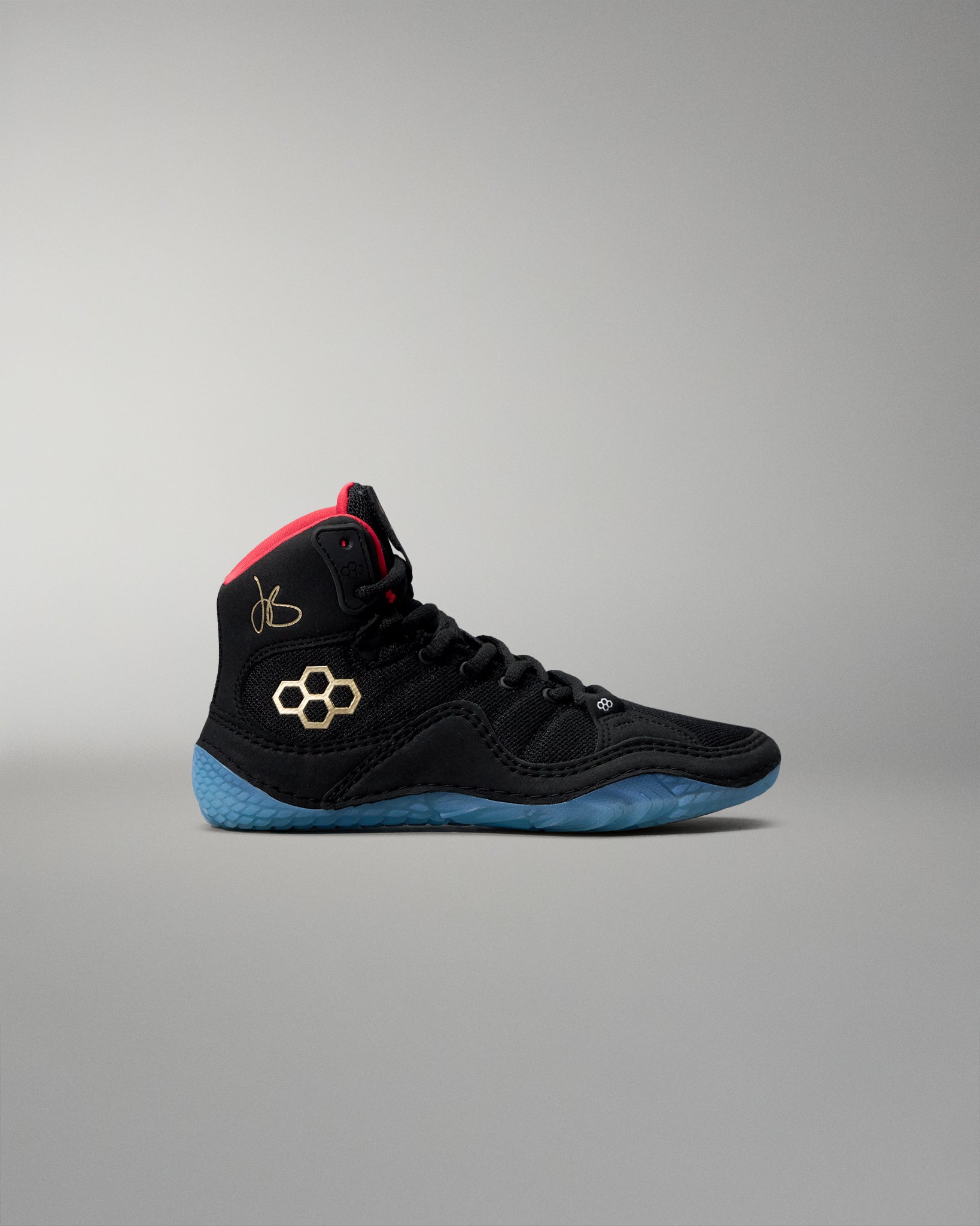 Black wrestling shoe with blue sole on a gray background