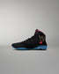 Black wrestling shoe with red and blue accents on a gray background