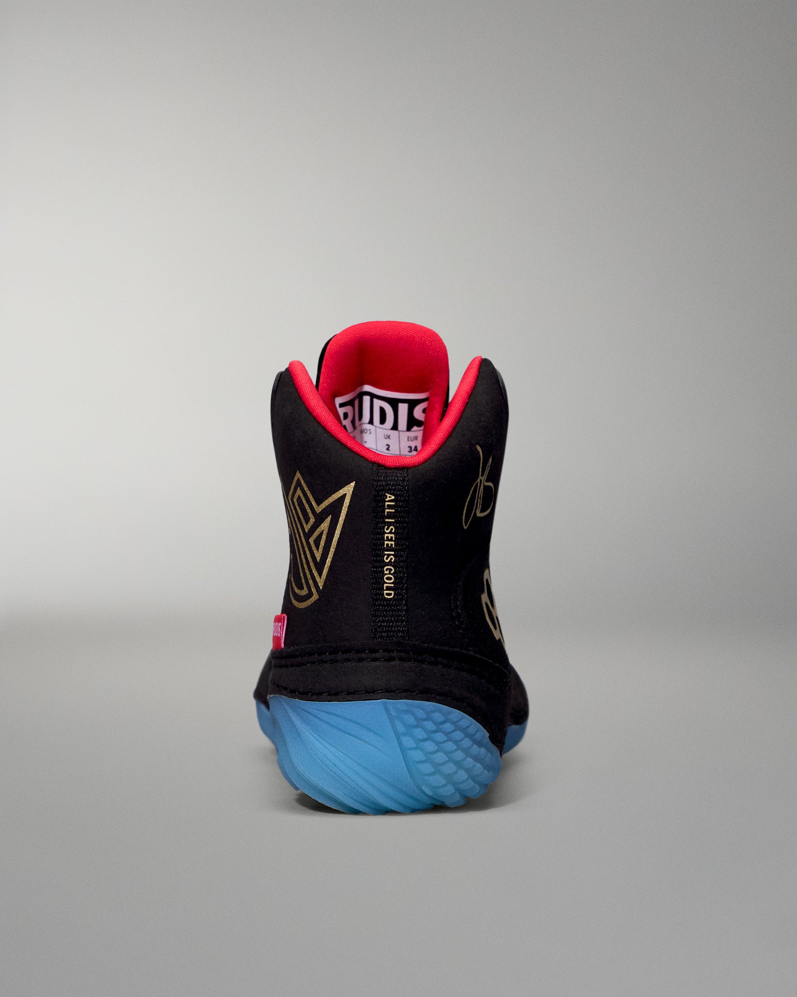 Black wrestling shoe with red lining and blue sole on a gray background