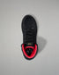 Black wrestling shoe with red lining on a gray background