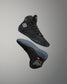 Black high-top wrestling shoe with brand logo on a gray background