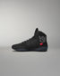 Black high-top wrestling shoe with a logo on a gray background