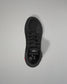 Black wrestling shoe on a light gray background