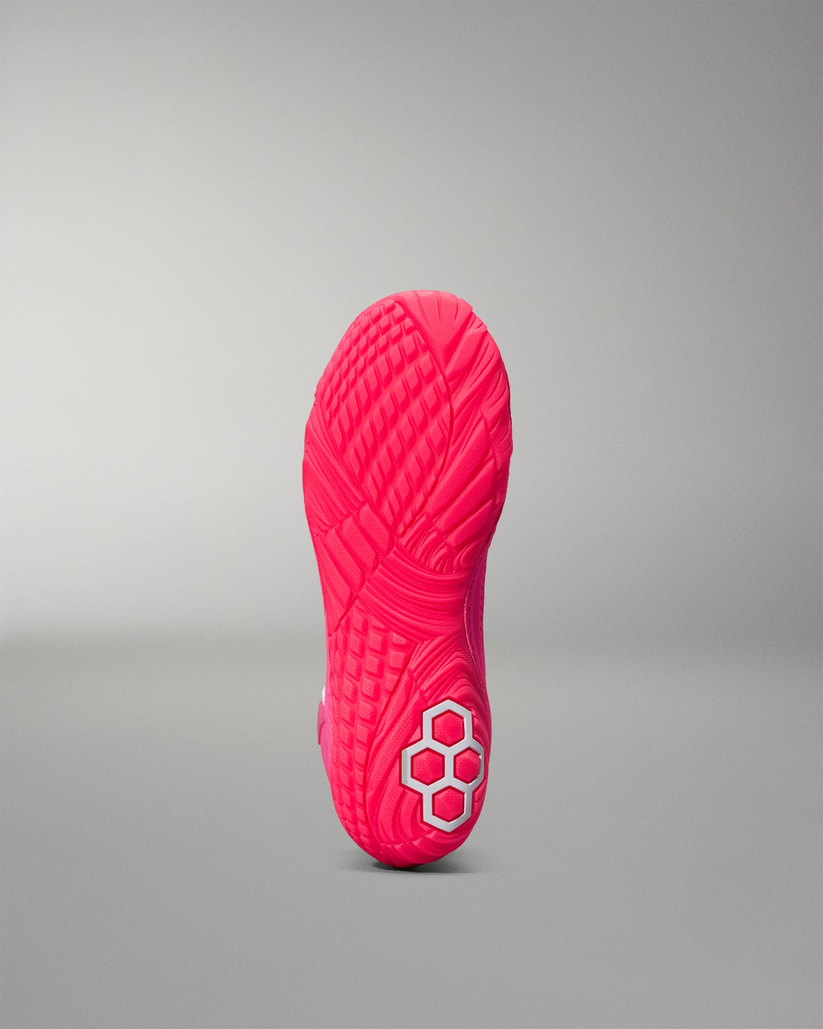 Pink wrestling shoe sole with a brand logo on a gray background