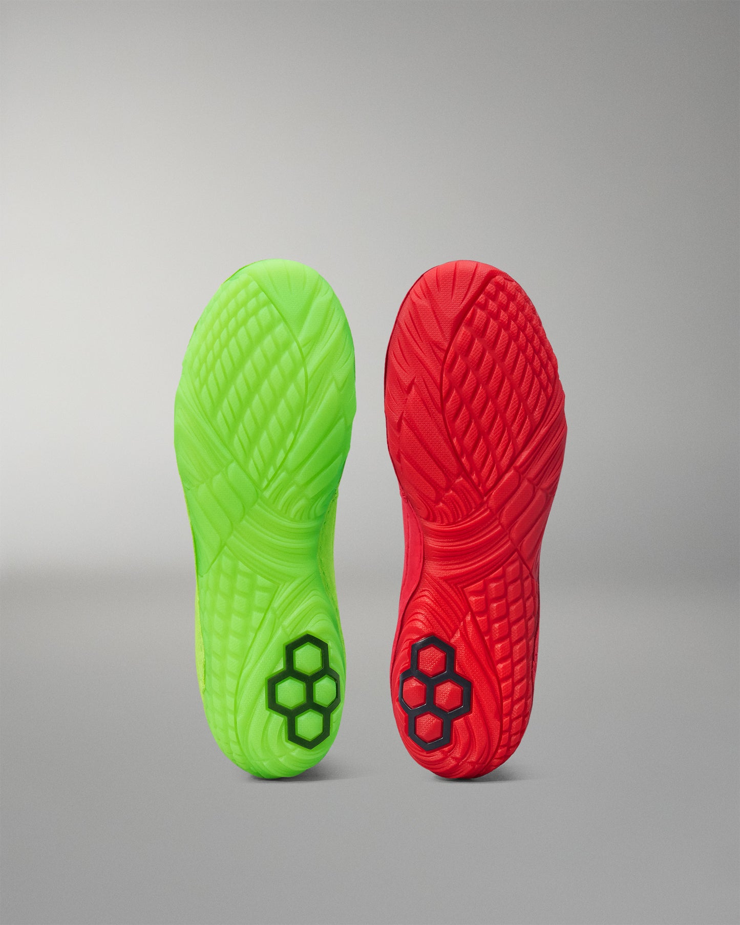 Green and red Wrestling shoe sole with brand logo on a gray background