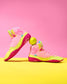 Pair of neon pink and yellow Wrestling shoes on a pink and yellow background