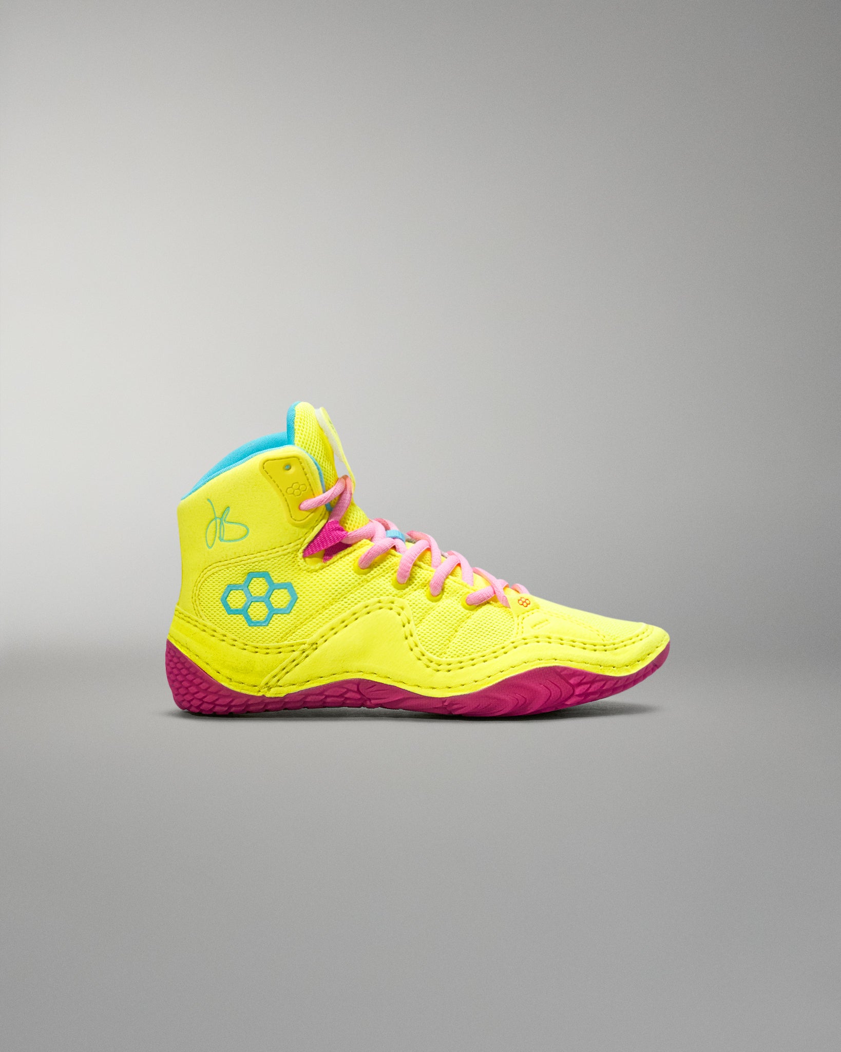 Neon yellow and pink Wrestling shoe with a colorful sole on a gray background