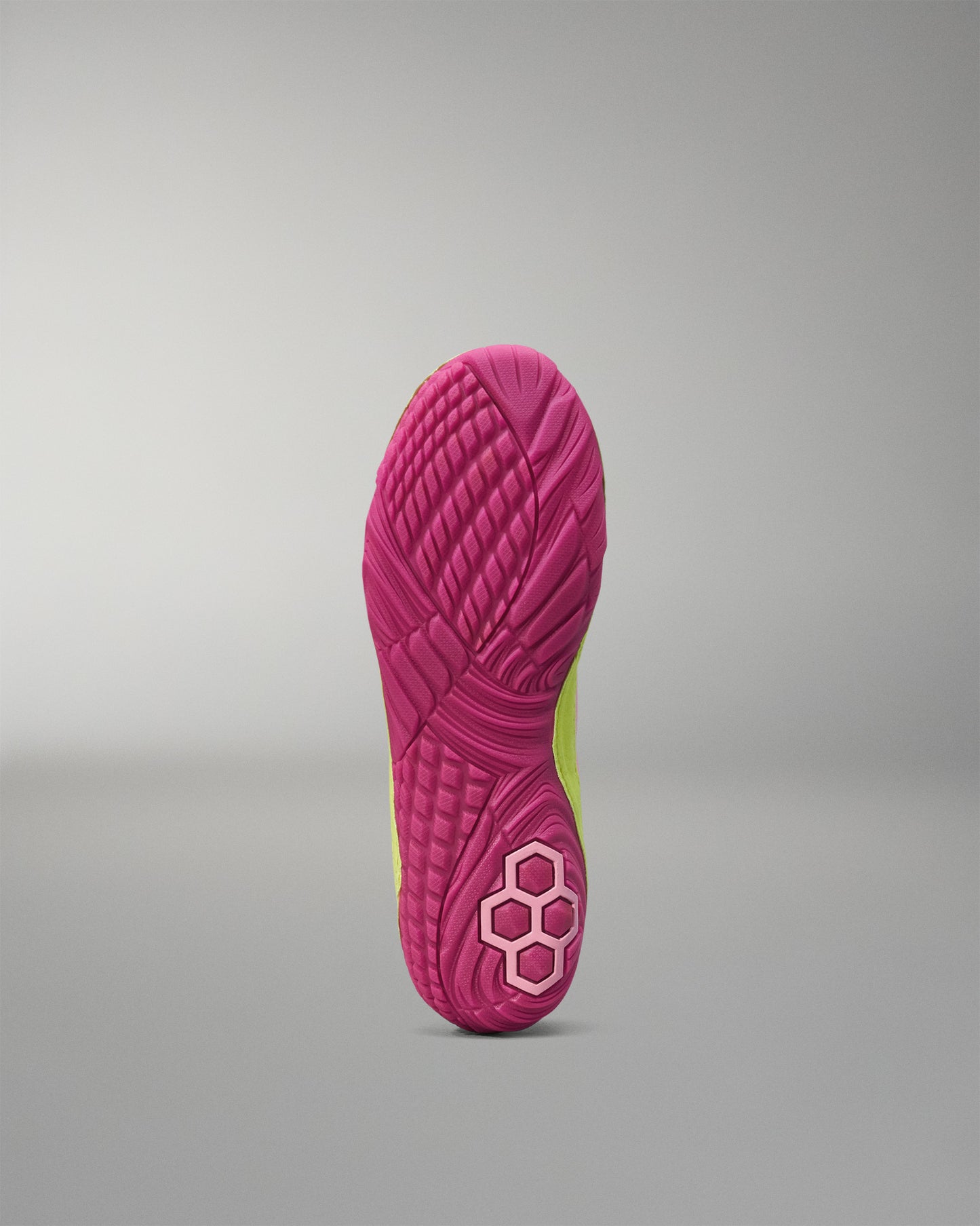 Close-up of a pink Wrestling shoe sole with a textured pattern on a gray background