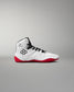 White wrestling shoe with red soles on a gray background
