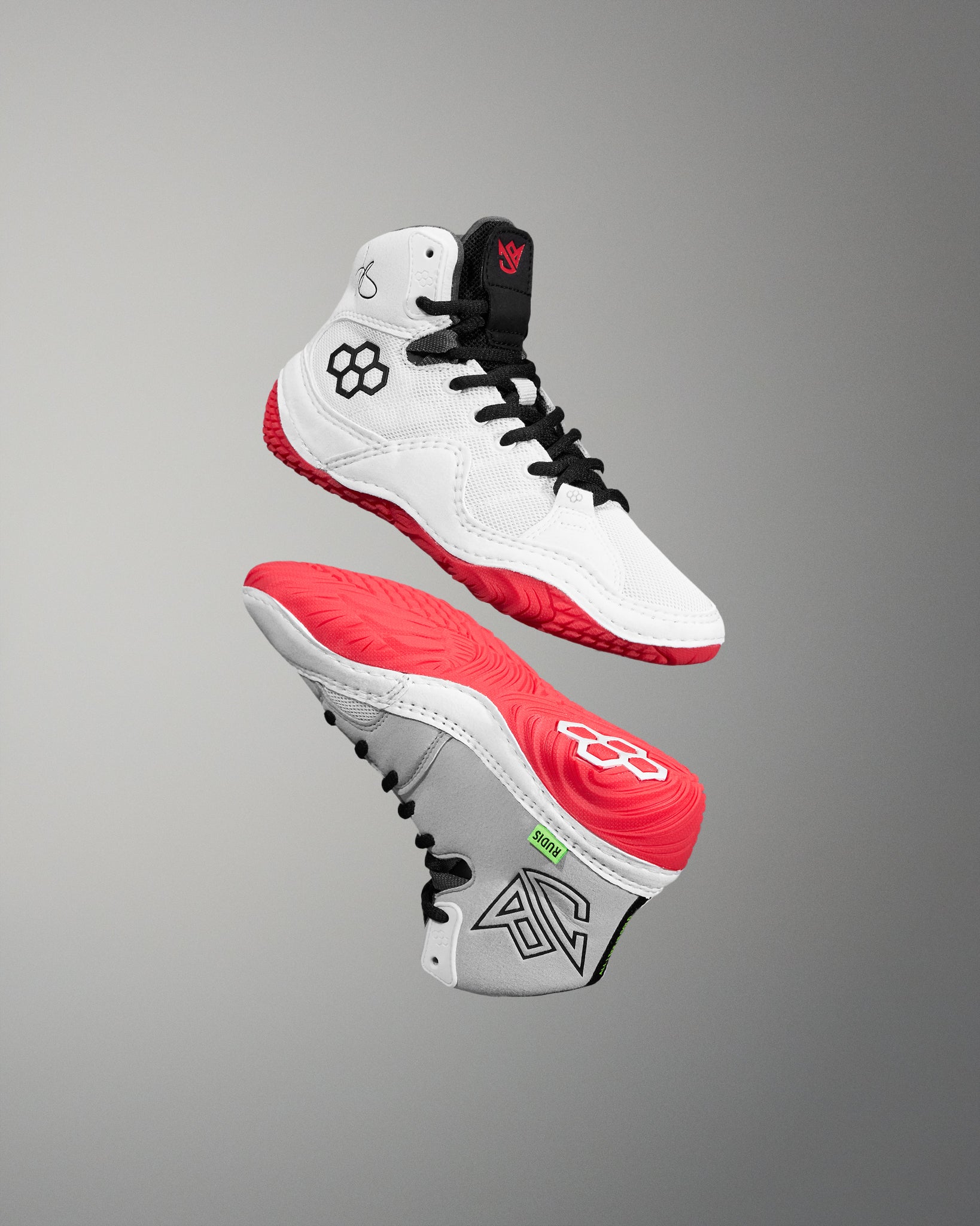White and red wrestling shoe with black accents on a gray background
