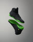 Black Wrestling shoes with green soles on a gray background