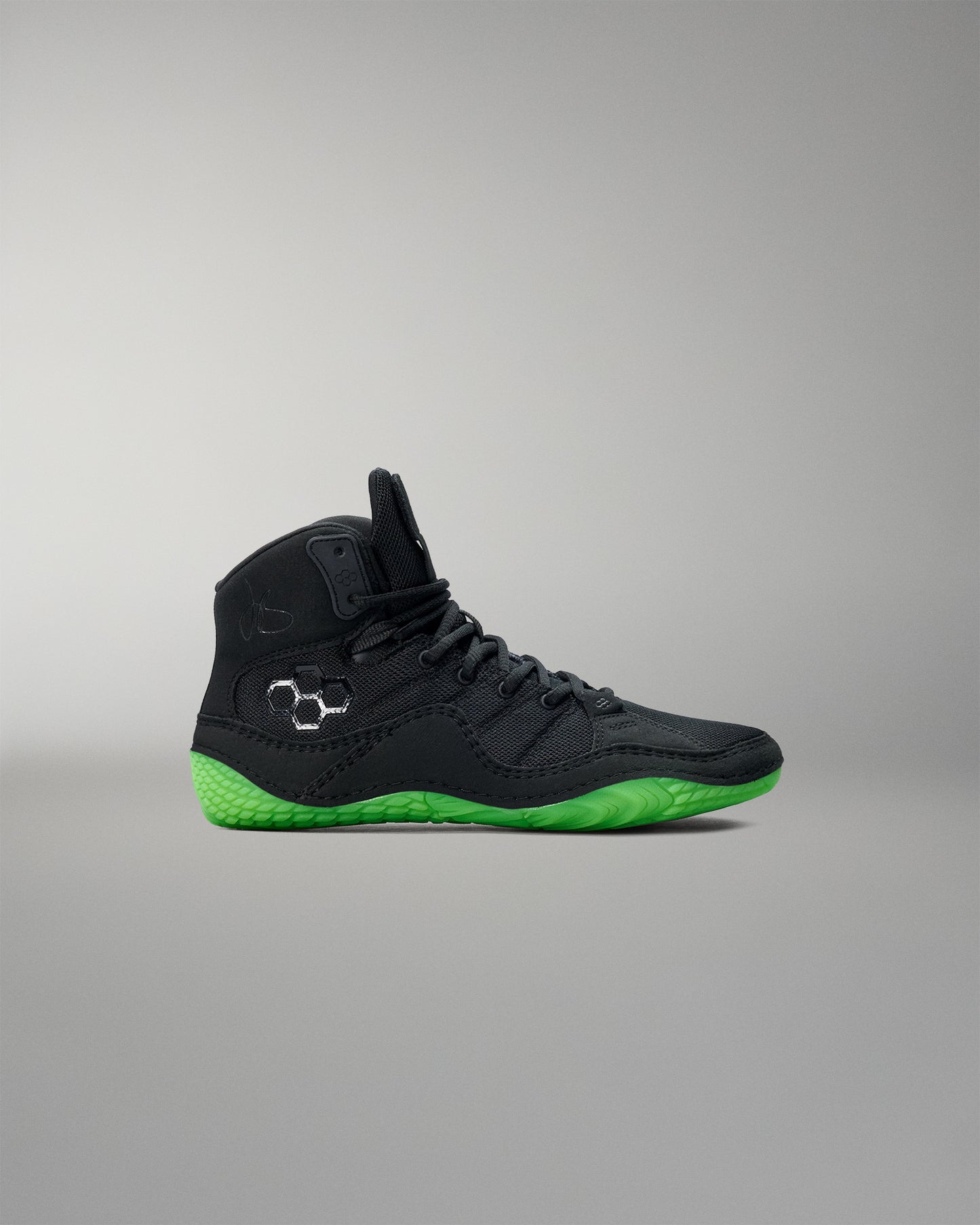 Black Wrestling shoe with green sole on a gray background