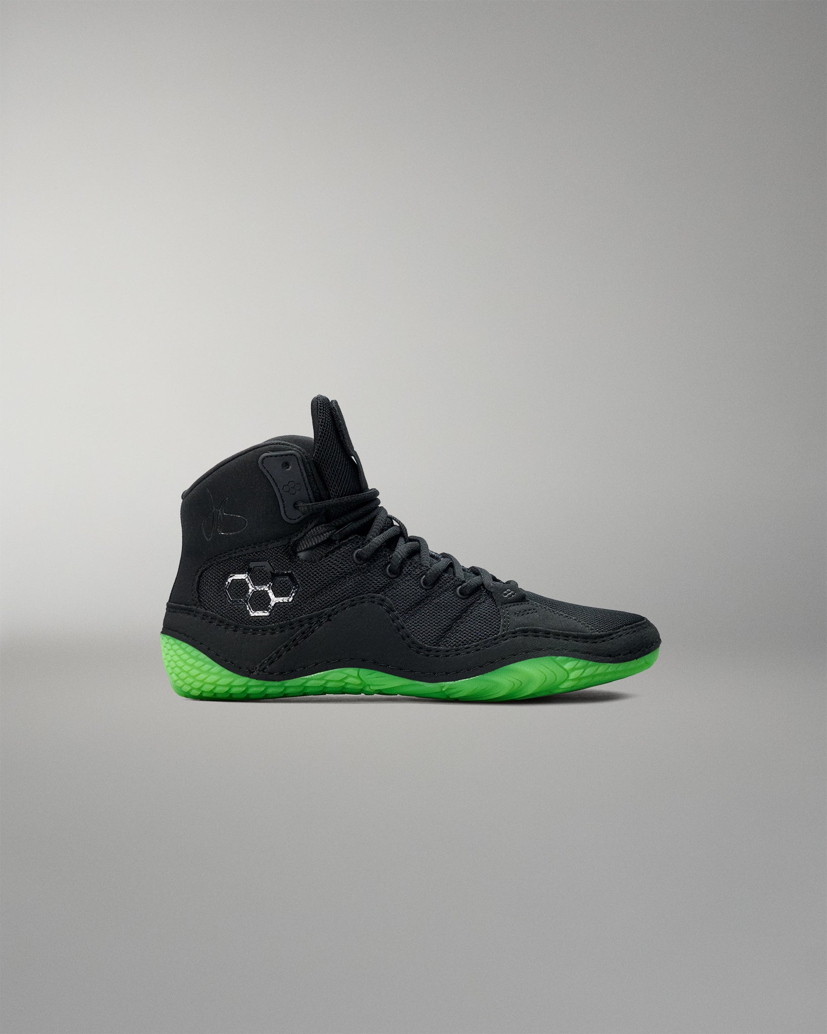 Black Wrestling shoe with green sole on a gray background