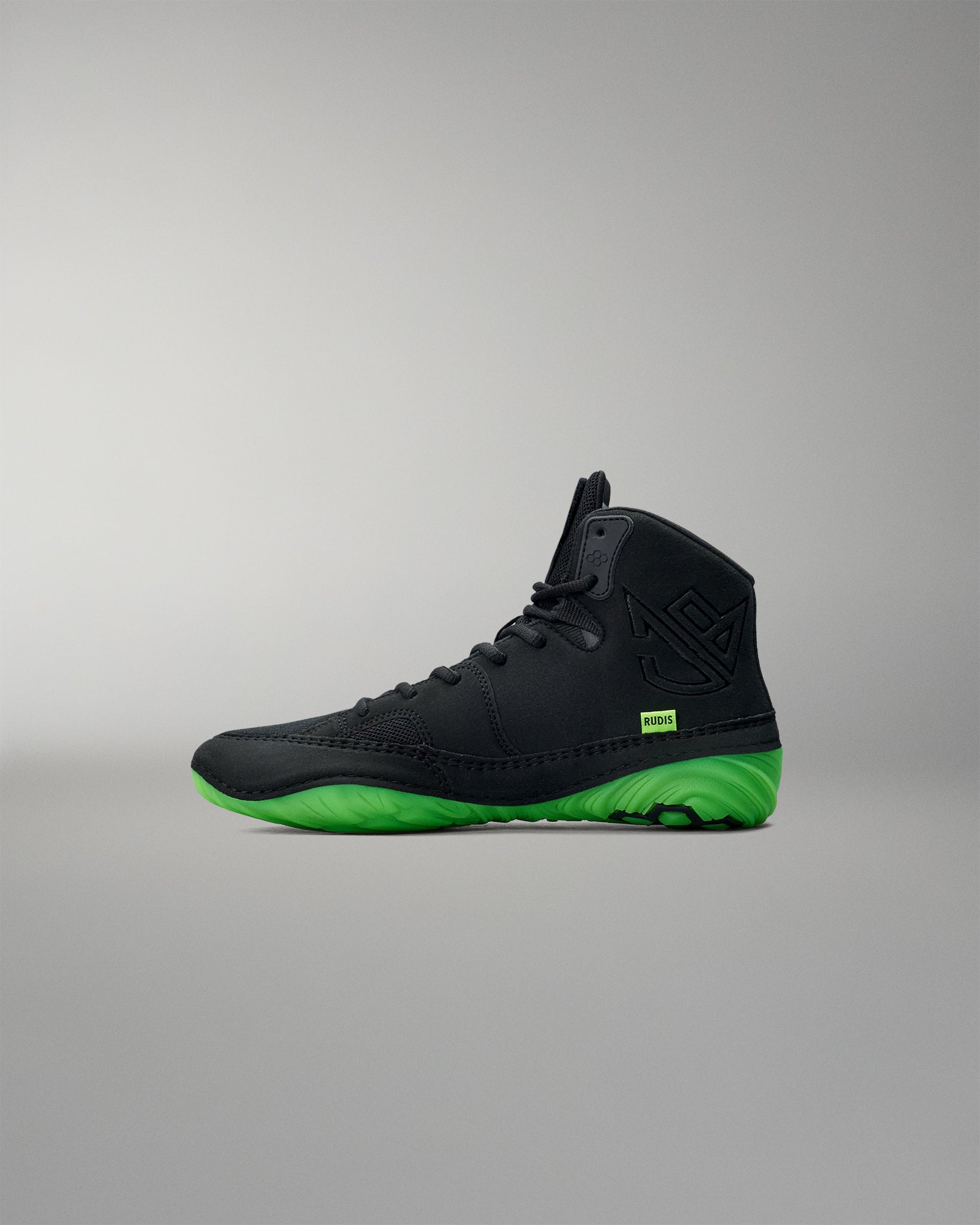 Black Wrestling shoe with green sole on a gray background