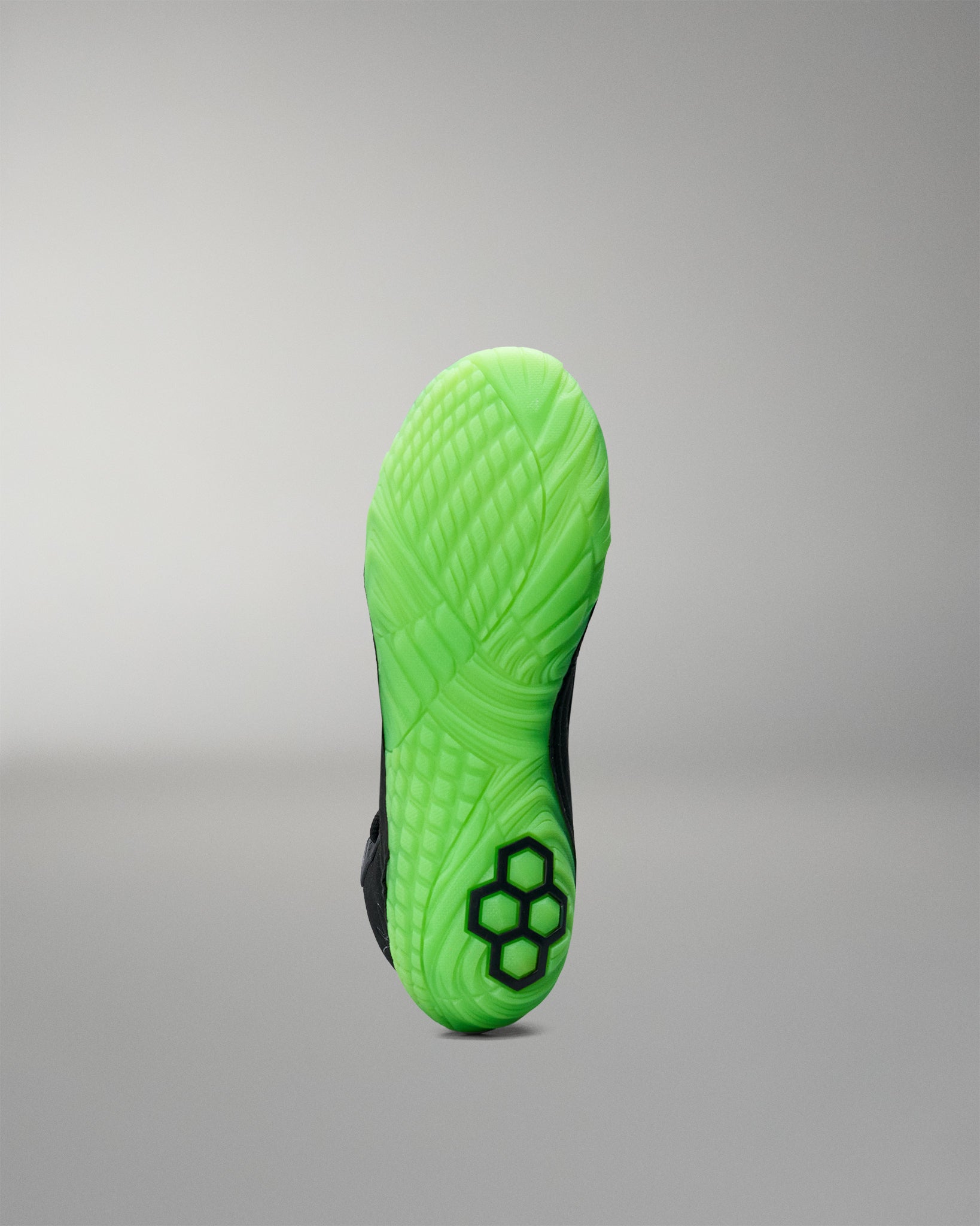Green sole of a Wrestling shoe on a gray background