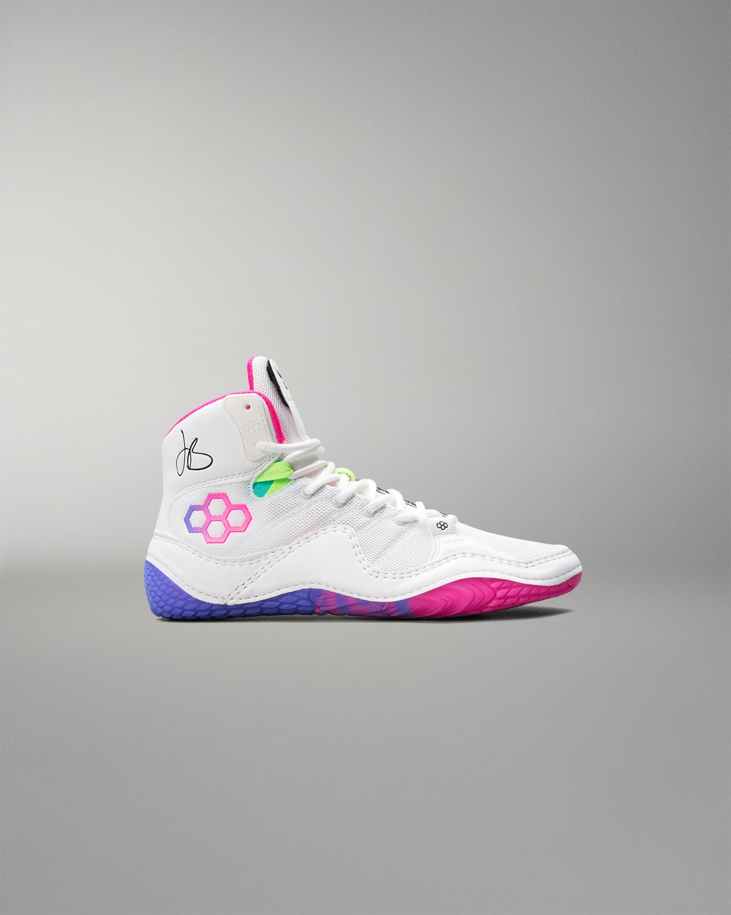 White wrestling shoe with colorful accents on a gray background