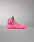 A bright pink high-top wrestling shoe with black accents, including a black floral logo on the side, black laces, and a black tongue, shown against a neutral gray background.