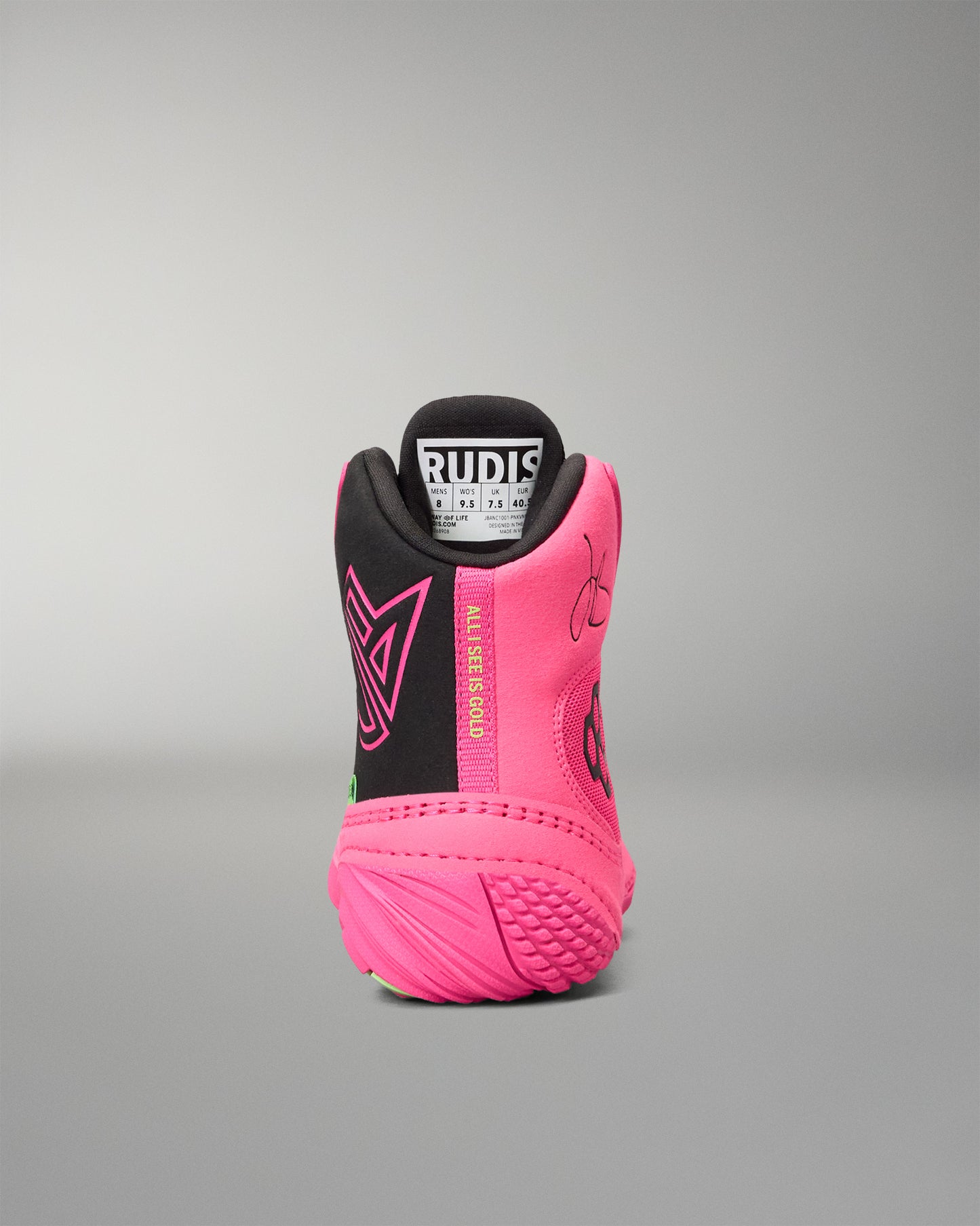 A high-top wrestling shoe shown from the rear, featuring a vibrant pink and black color scheme with a white and black Rudis logo on the tongue.
