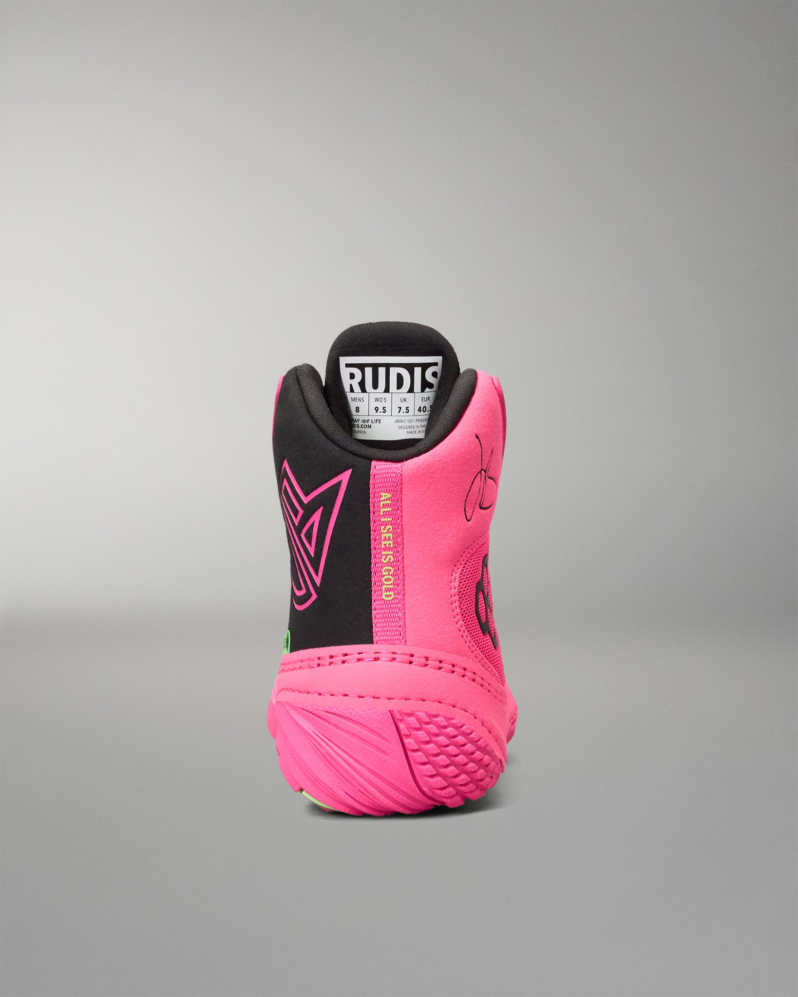 A high-top wrestling shoe shown from the rear, featuring a vibrant pink and black color scheme with a white and black Rudis logo on the tongue.