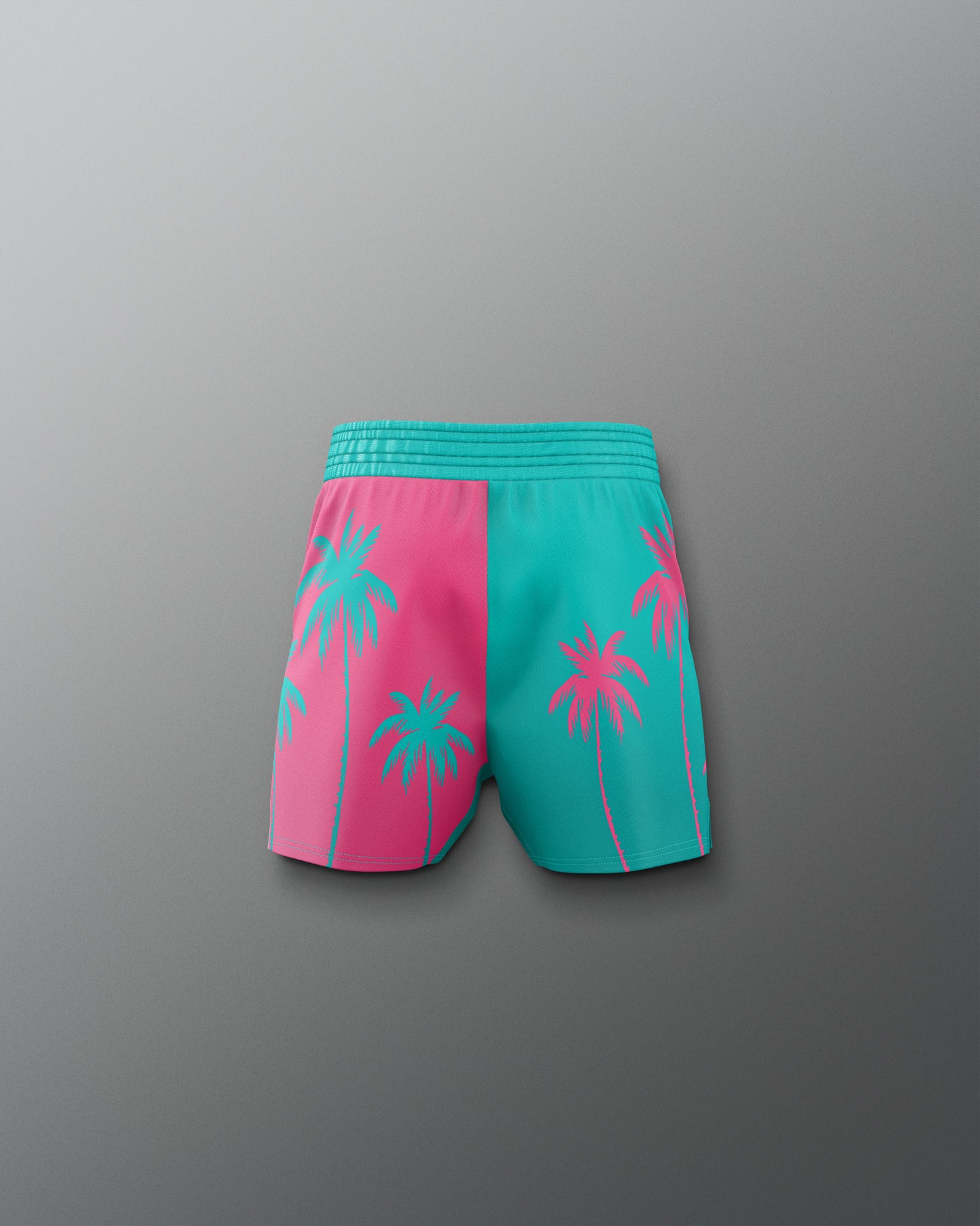 Pink and teal shorts with palm tree design on a gray background
