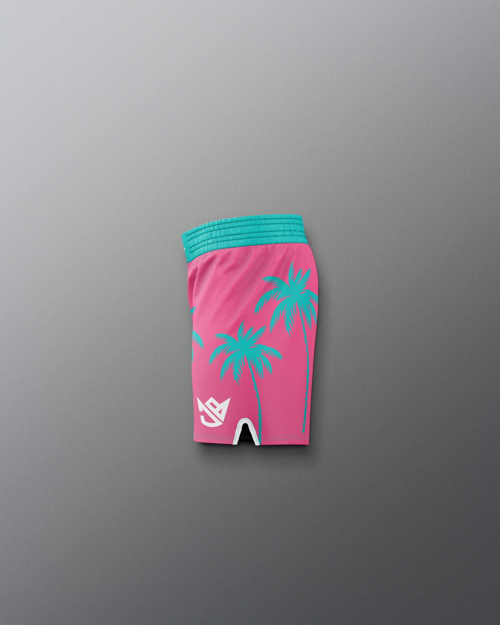 Pink shorts with green palm tree patterns and a blue waistband on a gray background