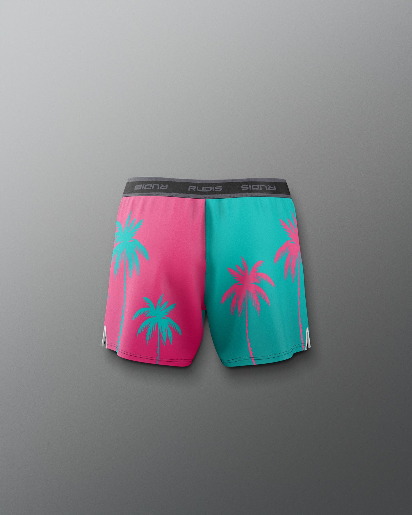 Pink and teal shorts with palm tree design on a gray background