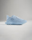A light blue athletic shoe featuring a breathable mesh upper patterned detailing and a cushioned sole for comfort and performance