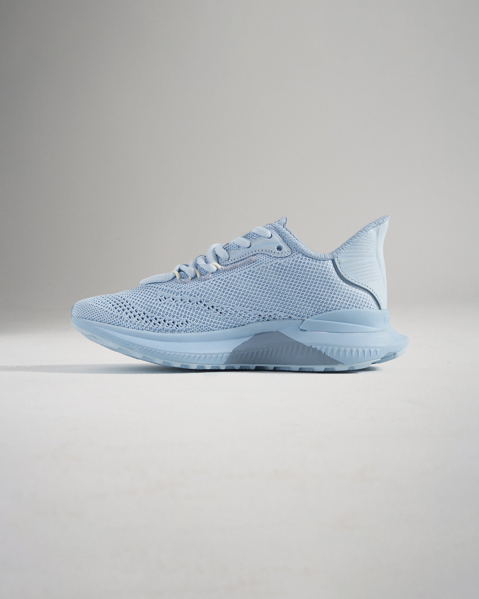 A modern light blue athletic shoe featuring a breathable mesh upper sleek athletic design and a supportive sole for running or casual wear