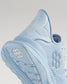 A close-up view of a light blue athletic shoe featuring a textured mesh upper and a detailed sole design emphasizing comfort and performance