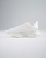 A side view of a sleek white athletic shoe featuring a breathable design and cushioned sole ideal for fitness activities